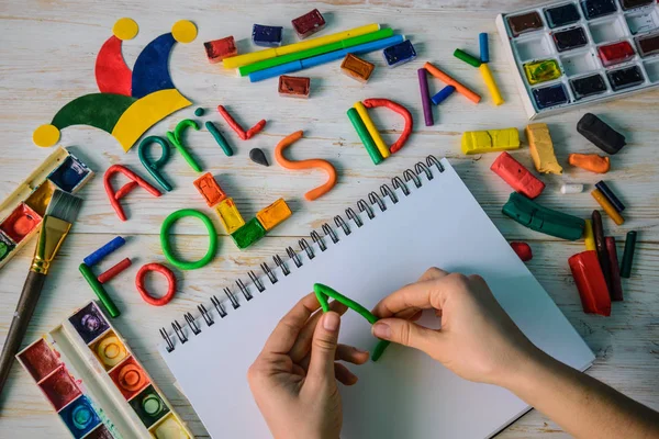 Hands make April Fools Day text made with plasticine — Stock Photo, Image