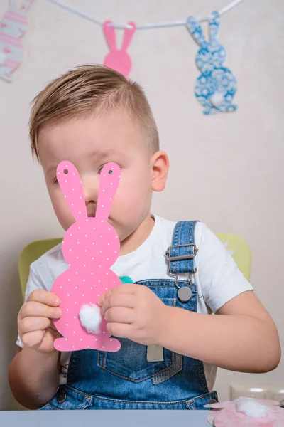 Lächelnder Junge bastelt Häschen für Ostern — Stockfoto