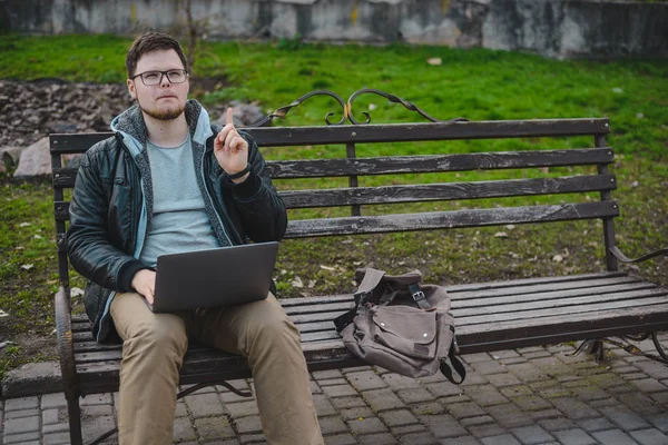 Young modern businessman working in park — Stock Photo, Image