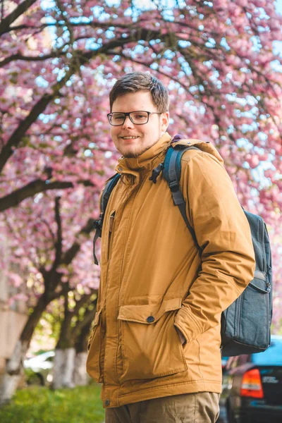 Портрет человека-янь в очках с цветущей сакурой — стоковое фото