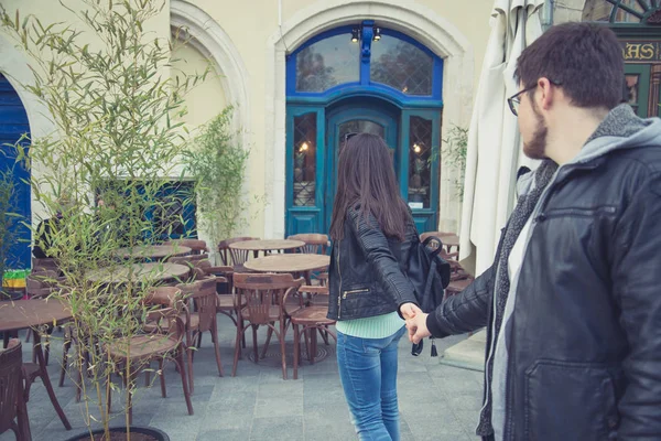 Woman pull man to the restaurant — Stock Photo, Image