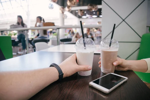 Woman and man hands holding smoothies — Stock Photo, Image
