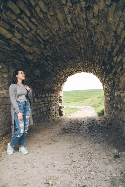 Femeia stă în tunelul castelului vechi — Fotografie, imagine de stoc