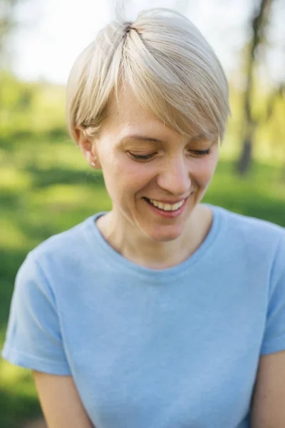 pretty blond with short cut smiling