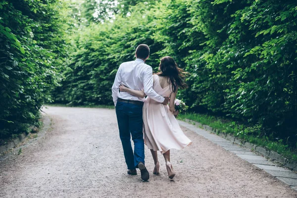 Man and woman walking in park in elegnance dress — Stock Photo, Image