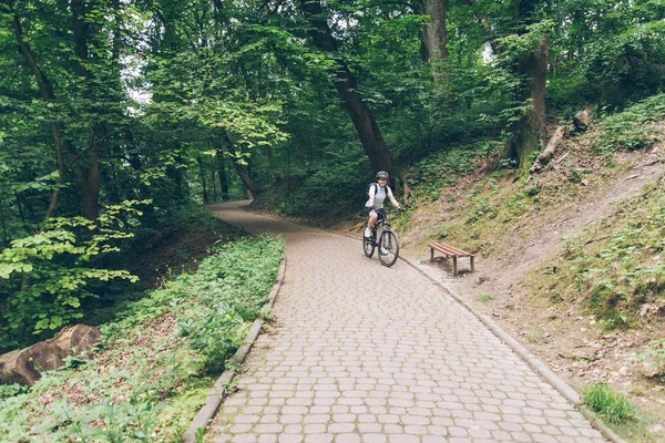 Frau fährt Fahrrad im Stadtpark — Stockfoto