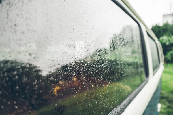 van window outside in rain drops