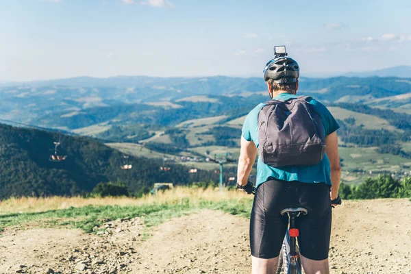 Young man riding on MTB in mountains — Stock Photo, Image
