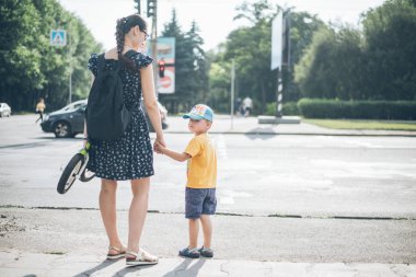 Anne oğlu ile trafik ışığı üzerinde duruyor