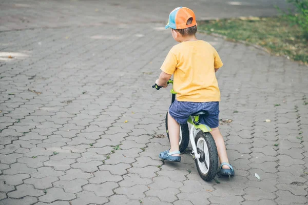 Young boy riding strider bike — Stock Photo, Image