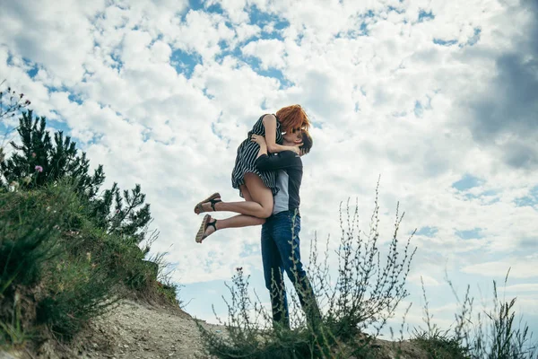 Young man hold woman on the peak — Stock Photo, Image