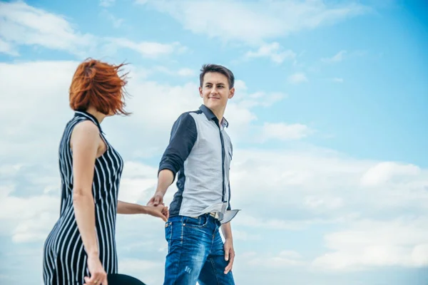 Man walks with woman and holds her hand — Stock Photo, Image