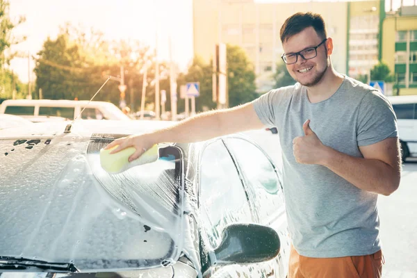 Homem woshing seu carro com esponja — Fotografia de Stock