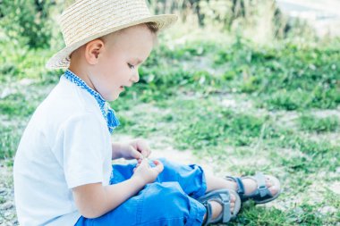 küçük çocuk yere dağların tepesinde oturan