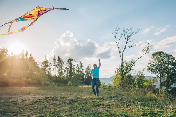 man plays with Kite in the sky