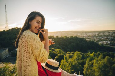 tepenin zirvesine oturan genç güzel kadın