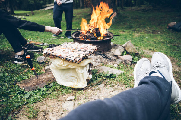 man sitting near bonfire and resting