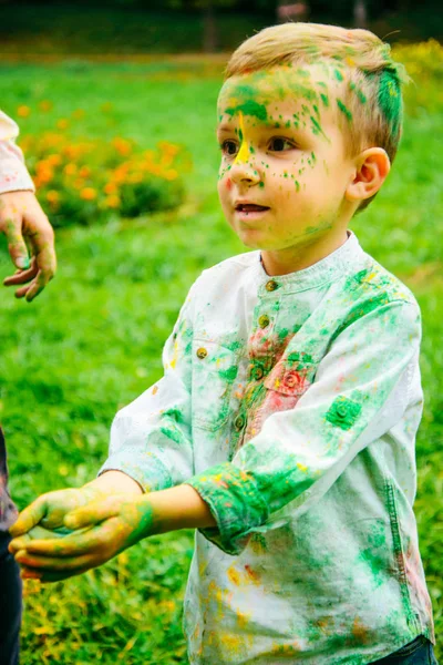 Smillin niño en pinturas holi en el parque de la ciudad — Foto de Stock