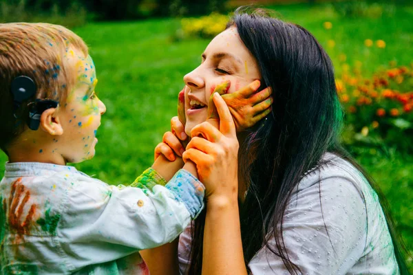 Mutlu anne ve oğlu bayram boyalar ile oynamak