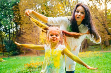 Baba Anne ve kızı çevresinde holi boyalar ile tam