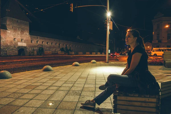 Uomo seduto e guardando la città di notte — Foto Stock