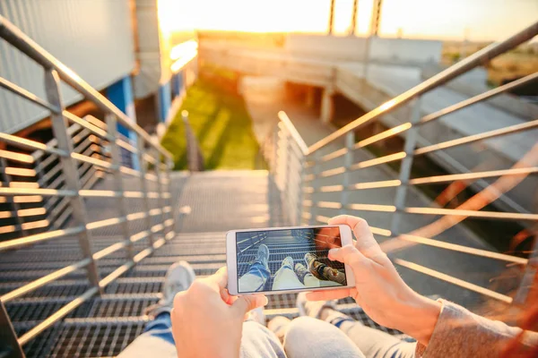 Man sitting on stairs and looking on sunset — Stock Photo, Image