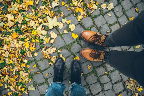 Couple boots top view with yellow leaves — Stock Photo, Image