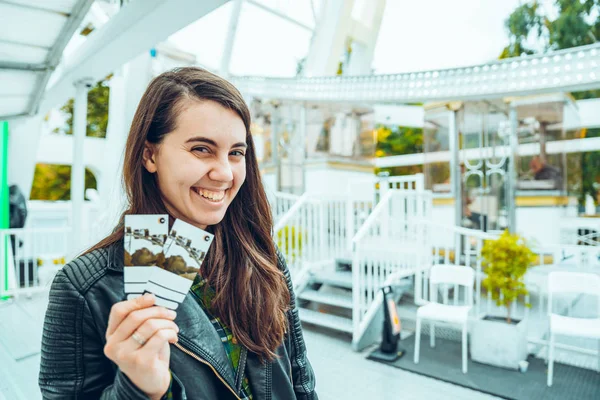 A beautiful woman holding two tickets — Stock Photo, Image