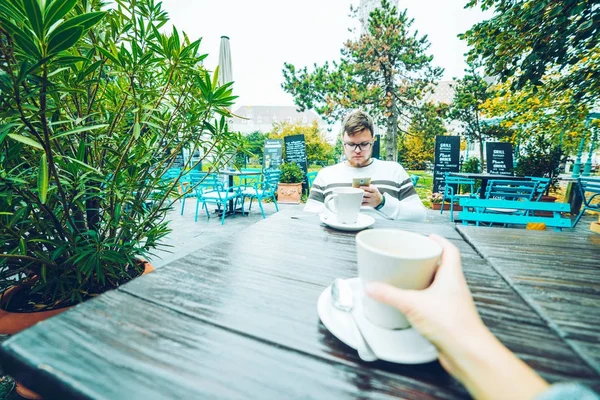 Pareja sentada en cafetería fuera de casa — Foto de Stock