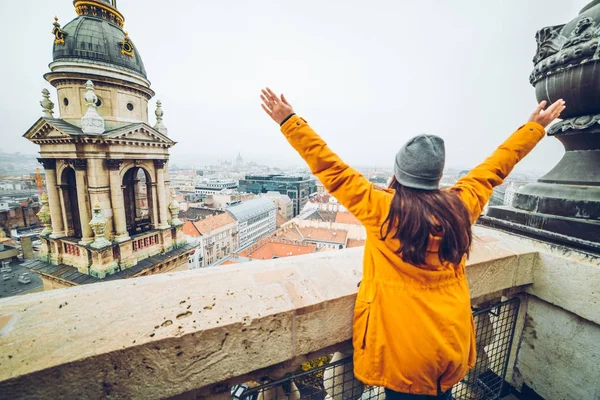 Женщина поднимается рука вверх с красивым видом на старый европейский город — стоковое фото
