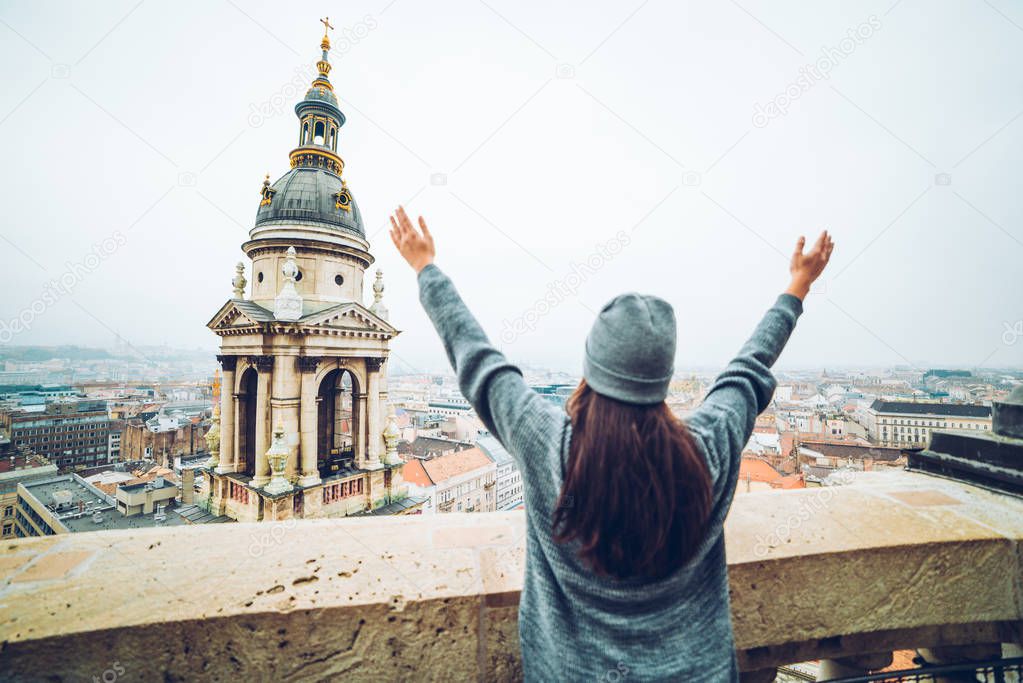 woman rise hand up with beautiful view at old european city