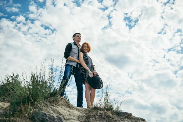 Young man with woman stands on the hill and looks straight ahead — Stock Photo, Image