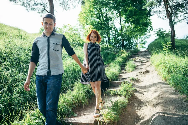 Lovely couple climbing up by the hill — Stock Photo, Image