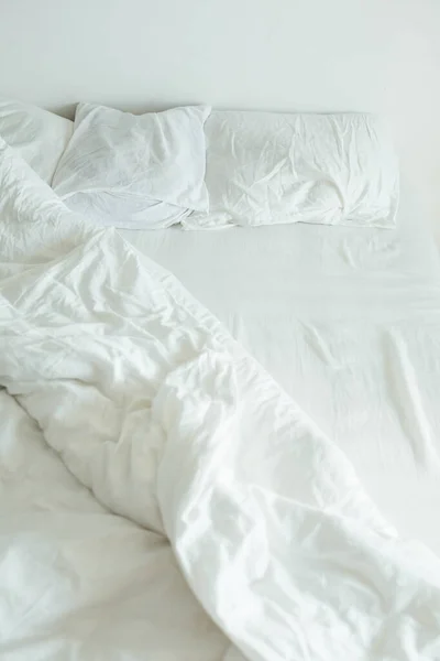 Bed with white sheets close up bright light — Stock Photo, Image