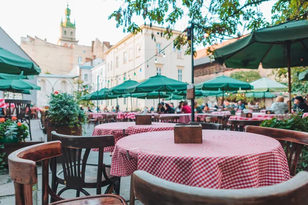 Personas comiendo hablando bebiendo en el restaurante cafetería al aire libre — Foto de Stock