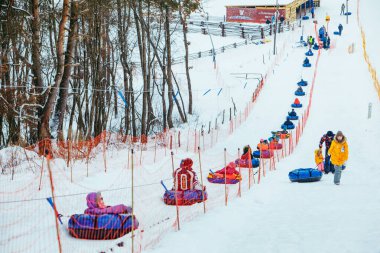 LVIV, UKRAINE - January 7, 2019: line for snow tubing. pull people up to hill.