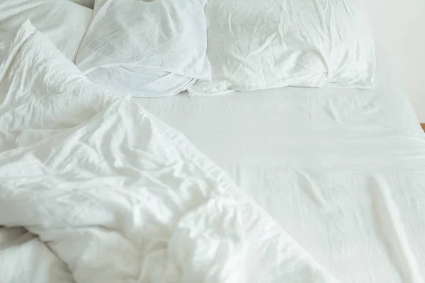 Bed with white sheets close up bright light — Stock Photo, Image