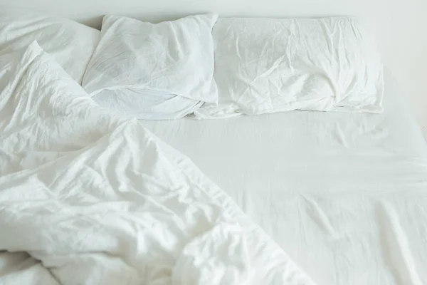 Bed with white sheets close up bright light — Stock Photo, Image