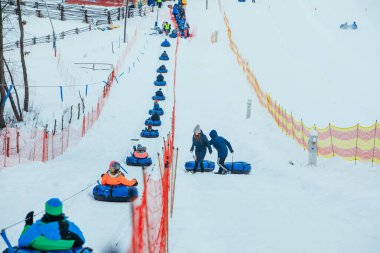 LVIV, UKRAINE - January 7, 2019: line for snow tubing. pull people up to hill.