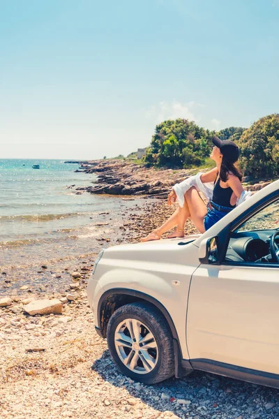 Frau liegt auf Motorhaube mit Blick auf Meer Sommerstrand — Stockfoto