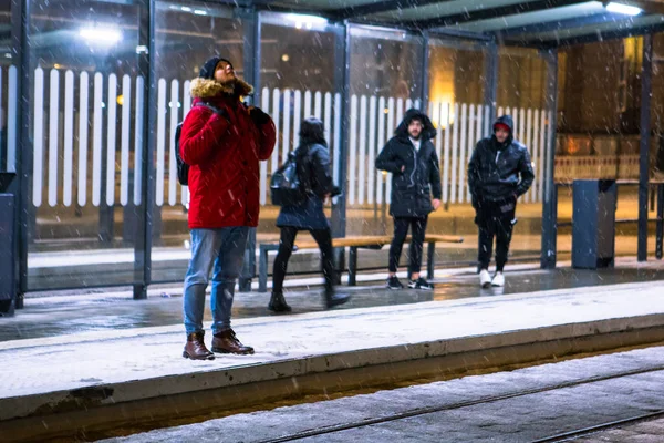 Man at winter snowed night at railway station waiting for tram — Stock Photo, Image