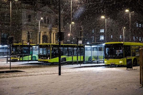 three buses at bus stop in front of reconstructed lviv railway station