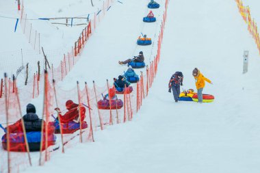LVIV, UKRAINE - January 7, 2019: line for snow tubing. pull people up to hill.