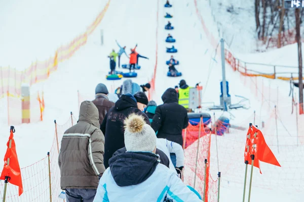 LVIV, UKRAINE - January 7, 2019: line for snow tubing. pull people up to hill. — Stok fotoğraf