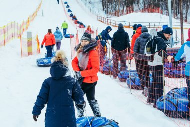 LVIV, UKRAINE - January 7, 2019: line for snow tubing. pull people up to hill.