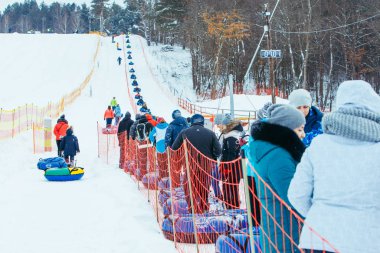 LVIV, UKRAINE - January 7, 2019: line for snow tubing. pull people up to hill.
