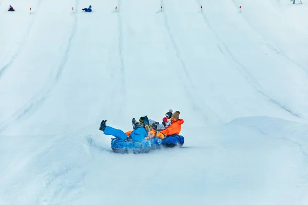 LVIV, UKRAINE - January 7, 2019: people having fun. snow tubing down by winter hill — Stock Photo, Image