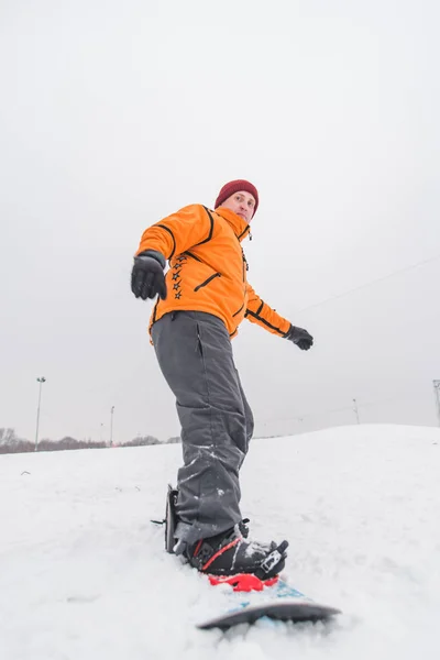 Człowiek snowboarding w dół przez wzgórze — Zdjęcie stockowe