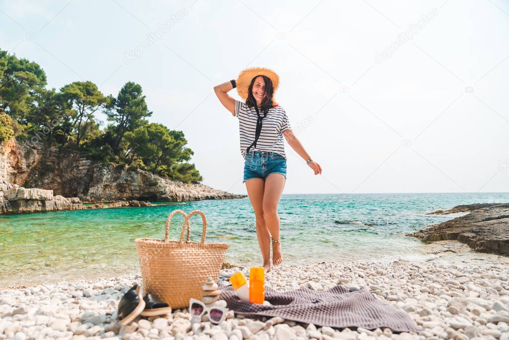 beach stuff straw hat and bag with flippers and sun protection cream