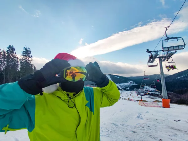 Happy man in ski outfit with santa red christmas hat at winter mountains hill — 스톡 사진